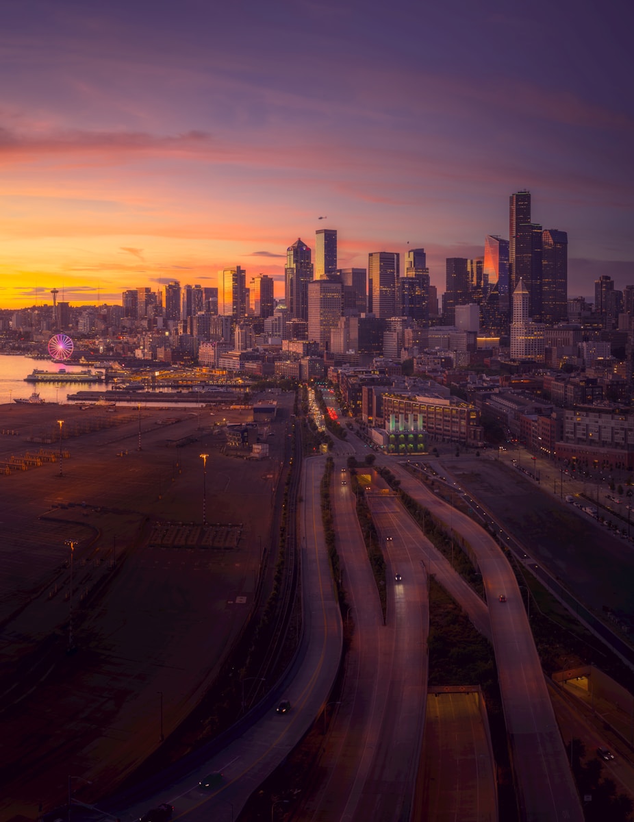 Photo by Zetong Li City skyline at sunset with glowing lights.